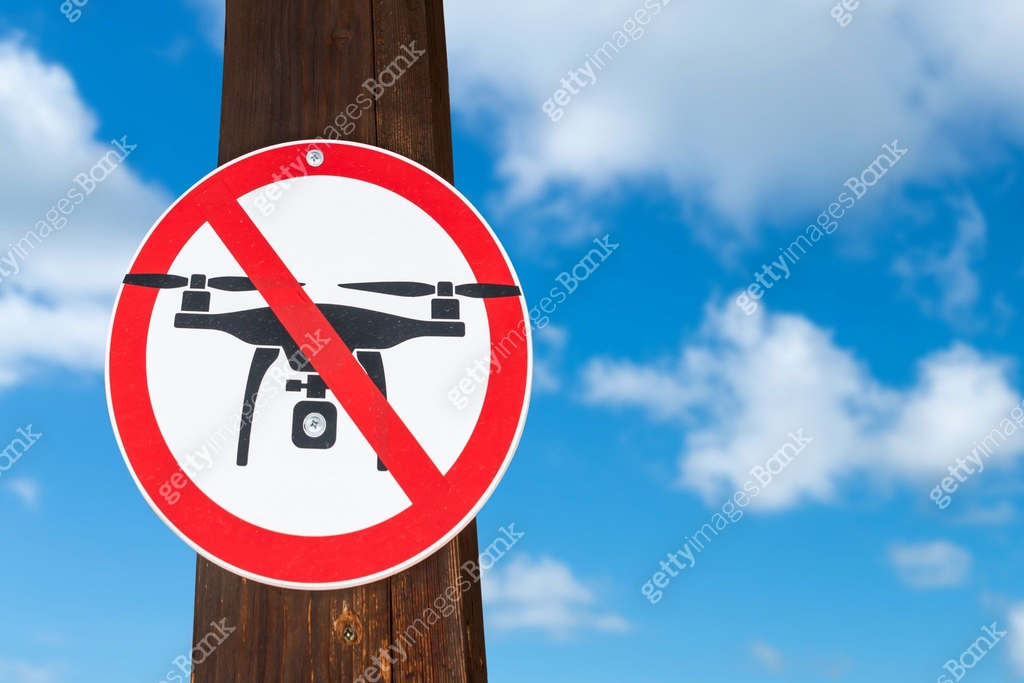 Flying Sign Ban on flying drones. Crossed out flying drone sign. Restrictions on ...