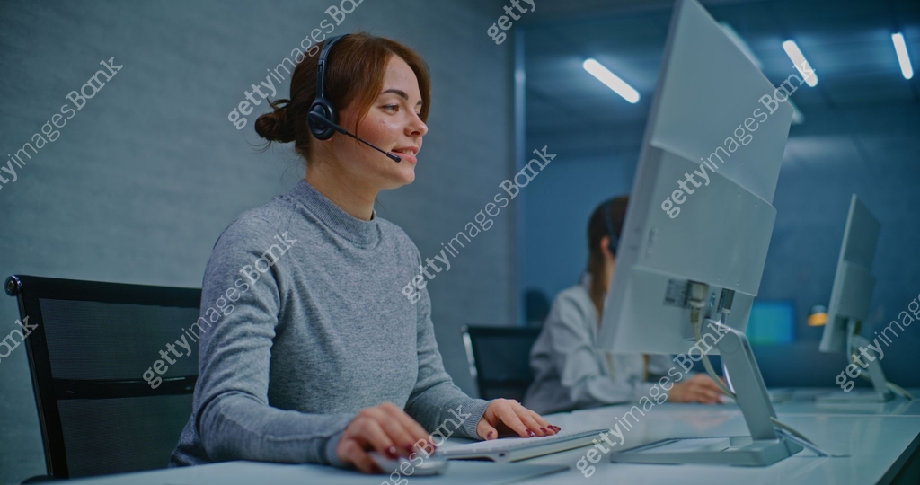 Call center: Female hotline operator talking on headset with customer ...
