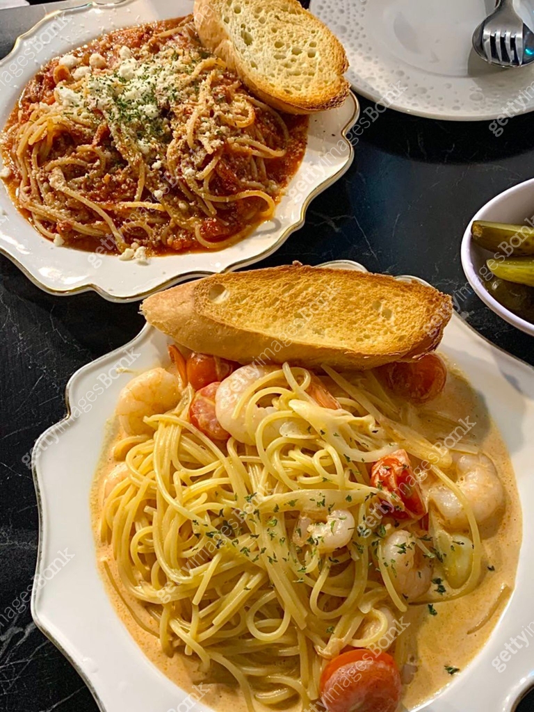 A plate of spaghetti pasta, perfectly cooked and topped with rich ...