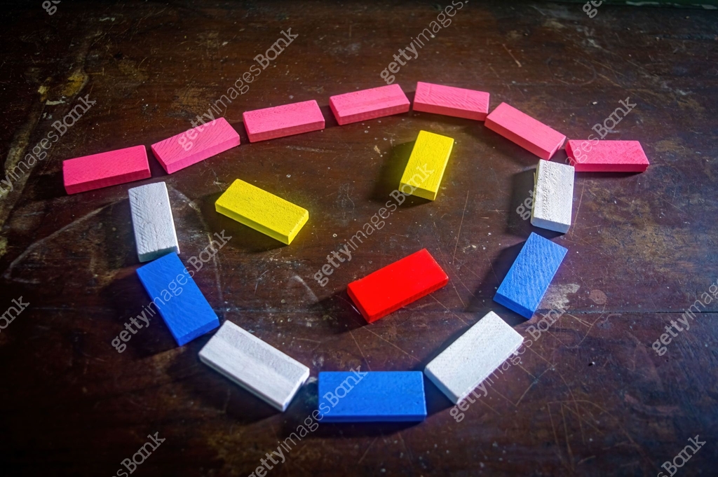Angry Face Blocks Colorful wooden blocks arranged in an angry face on a dark wooden ...
