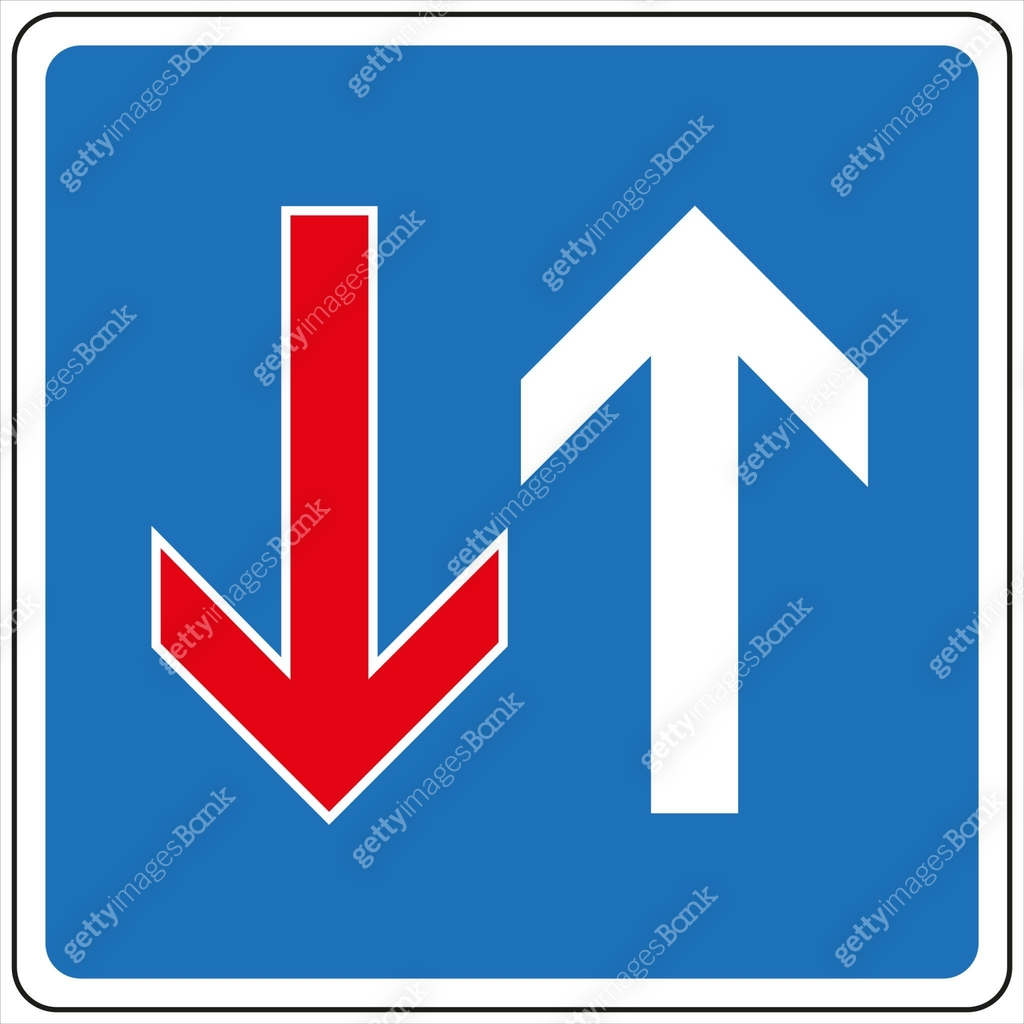 Blue and white priority road sign indicating upward direction of travel ...