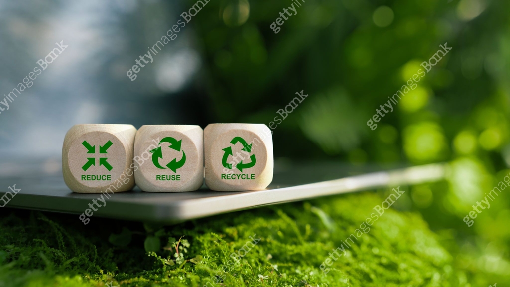 Three wooden blocks displaying Reduce, Reuse, Recycle symbols rest on a ...