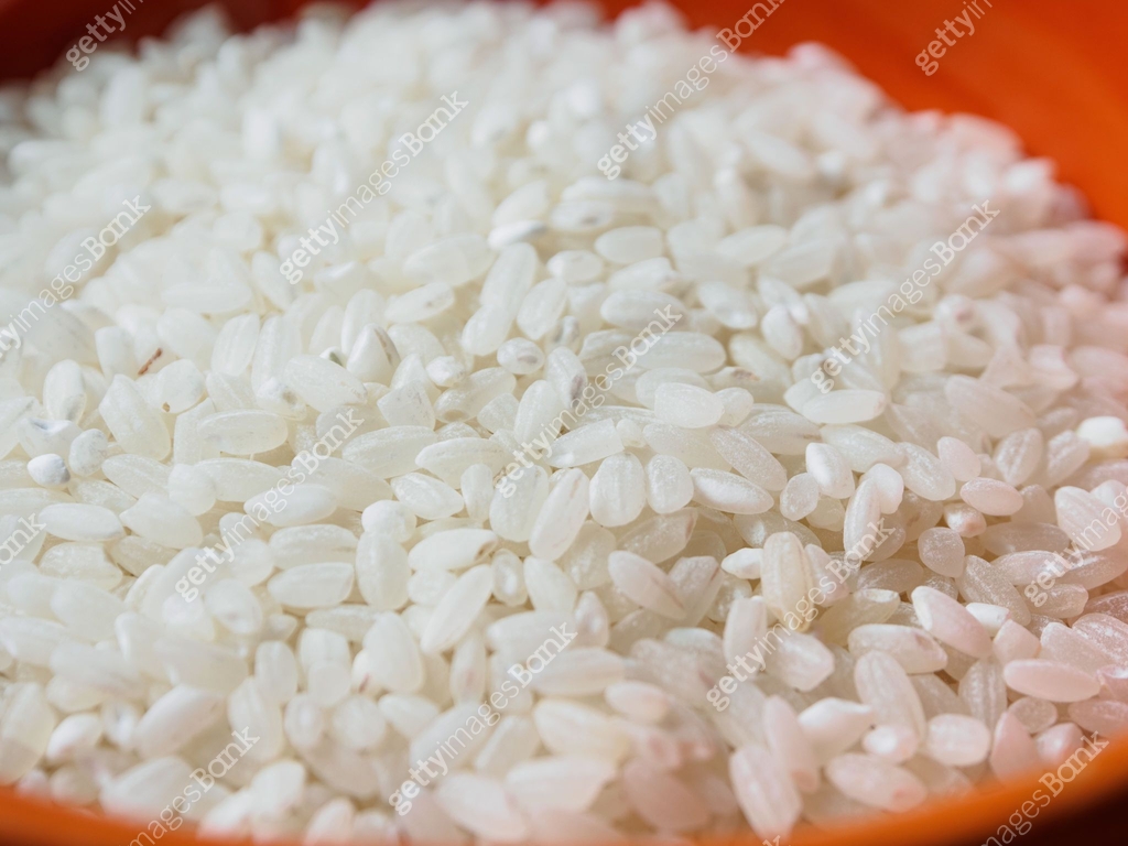 A close-up of round-grain rice, showing its shiny texture and natural ...