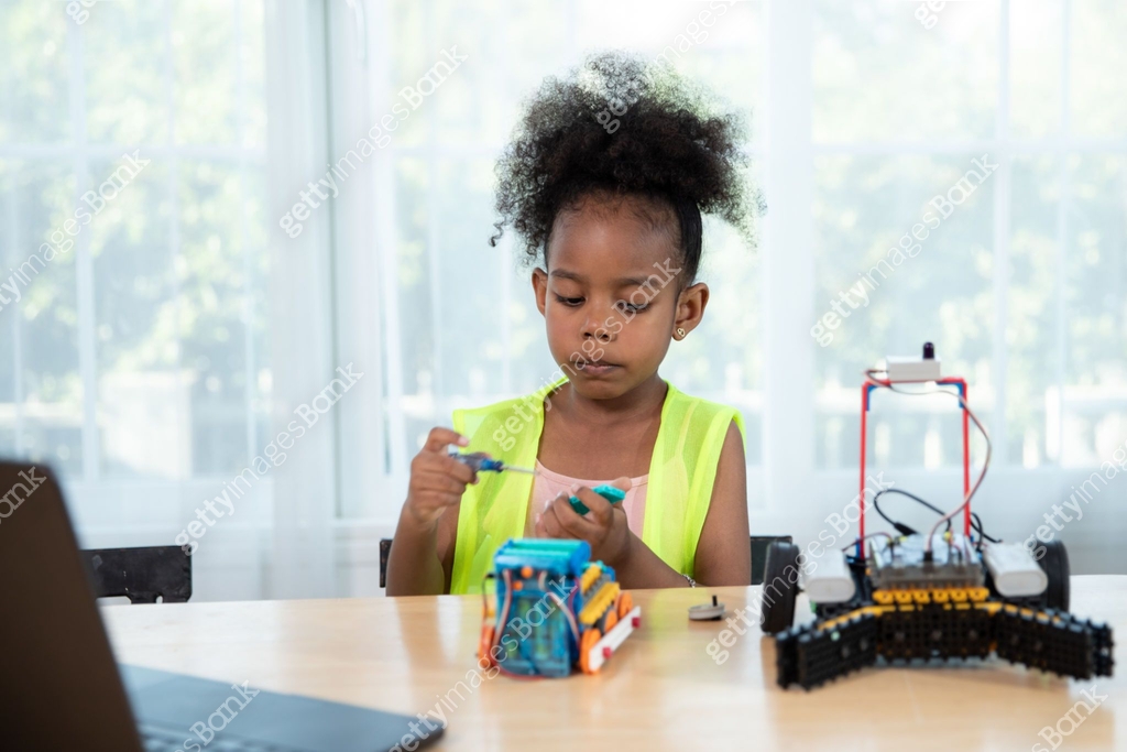 Young girl working on a robot design in Robotics programming class ...