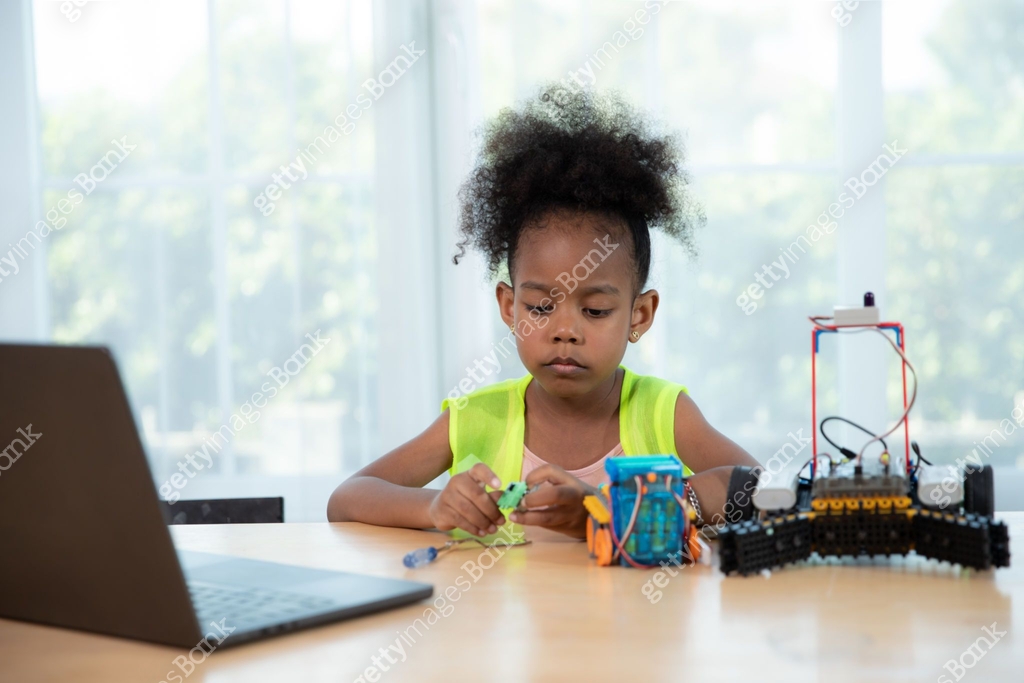 Young girl working on a robot design in Robotics programming class ...