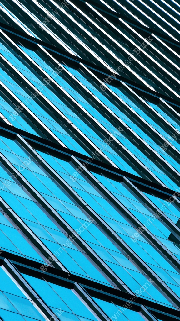 A striking architectural pattern of glass and steel panels forms a ...
