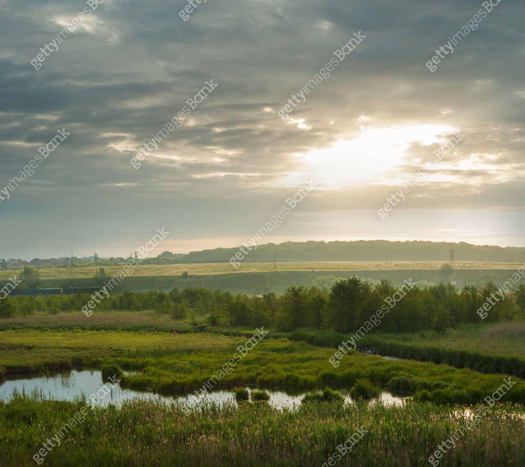Tranquil countryside under cloudy sky, wetlands, river floodplain of ...