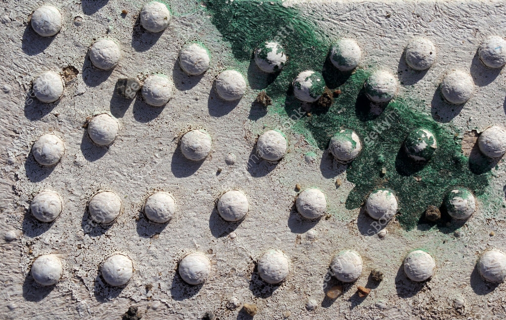 Round bumps on a white and green surface abstract textured background ...