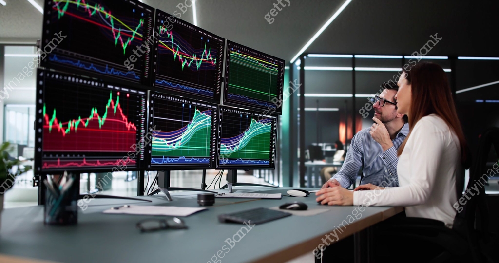Multiple Monitor Banking Stock trader analyzing market data on multiple monitors with financial ...