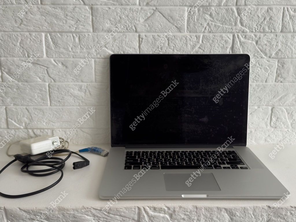 Plug in power outlet adapter cord charger on a white wall of the laptop ...