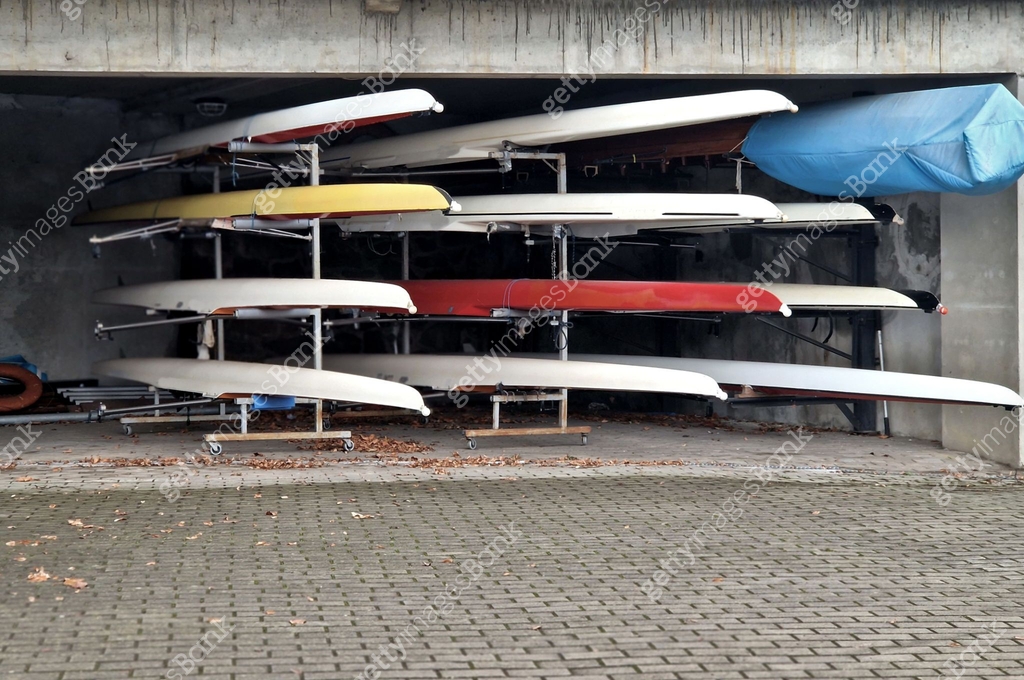 Rowing boats in storage in a rack in a garage. warehouse of laminate ...