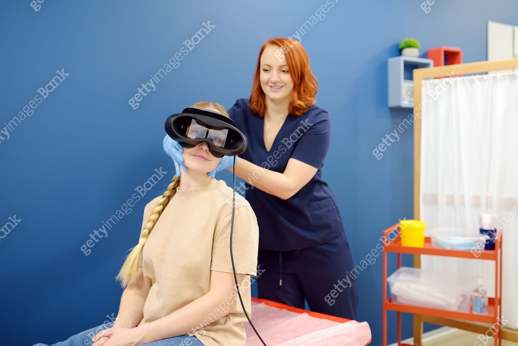 Neurologist performing positional testing of patient using ...