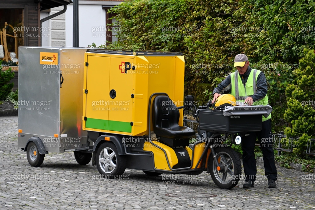 A Swiss Post letter carrier delivering mail in Beckenried on the ...