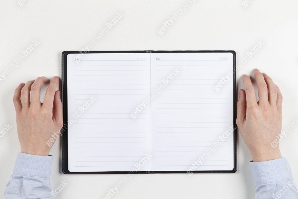 A close-up of a man's hand on a notepad 이미지 (vs12406914) - 게티이미지뱅크