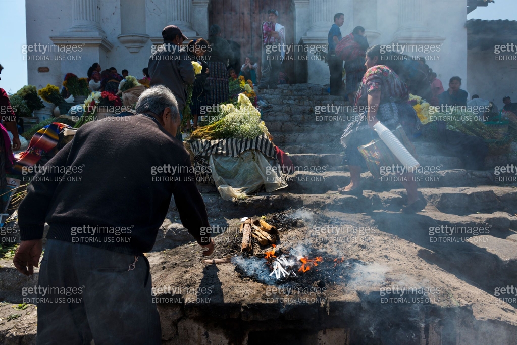 Man performing an ancient Maya ritual in the stairs of the Santo Tomas ...