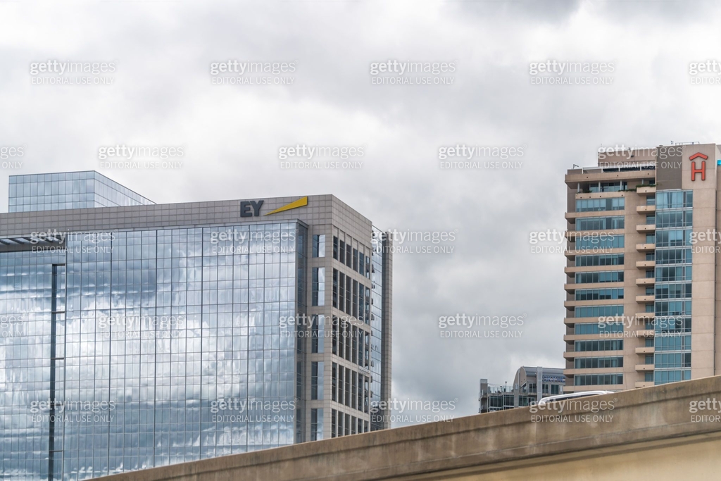 Downtown elevated highway ramp in city with sign on office buildings ...