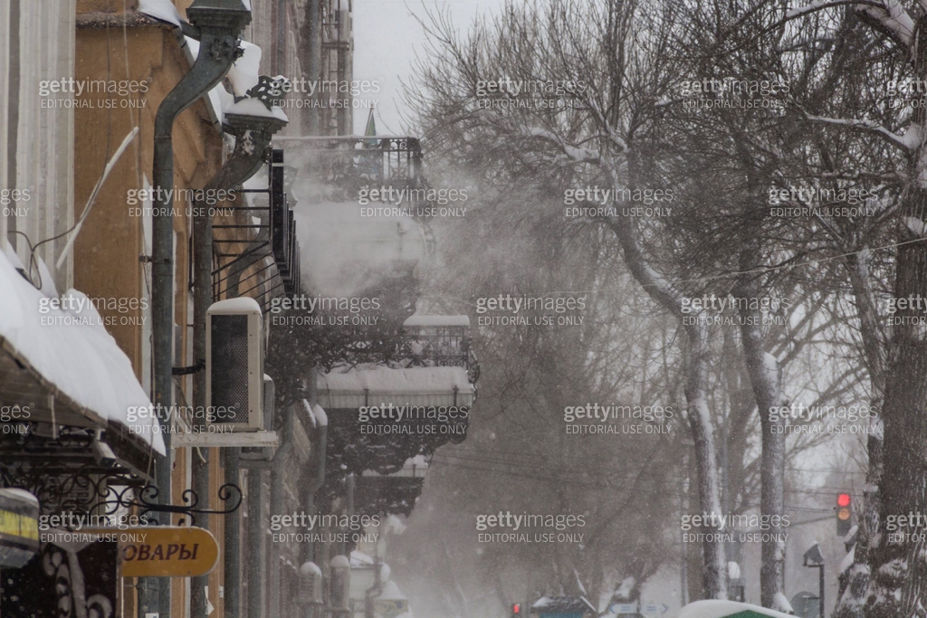 A snow blizzard in the city, bad weather, snow blows snow from the ...
