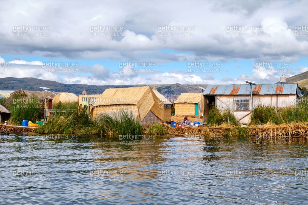 Floating islands with indigenous peoples houses made of reeds on ...