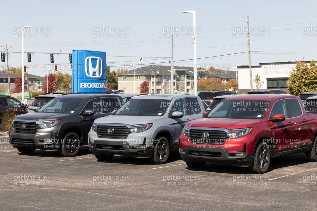 Different Ridgeline Models Honda Ridgeline display at a dealership. Honda offers the Ridgeline in ...