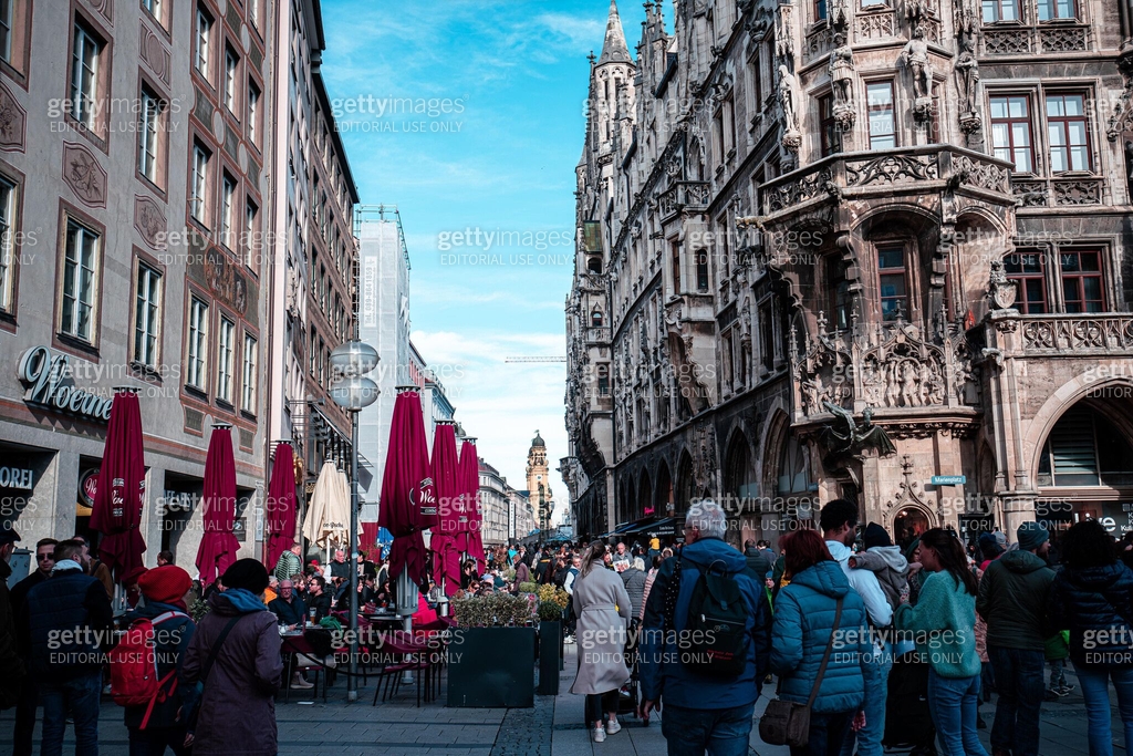 Historical streets of Munich's Altstadt with tourists and colorful buildings