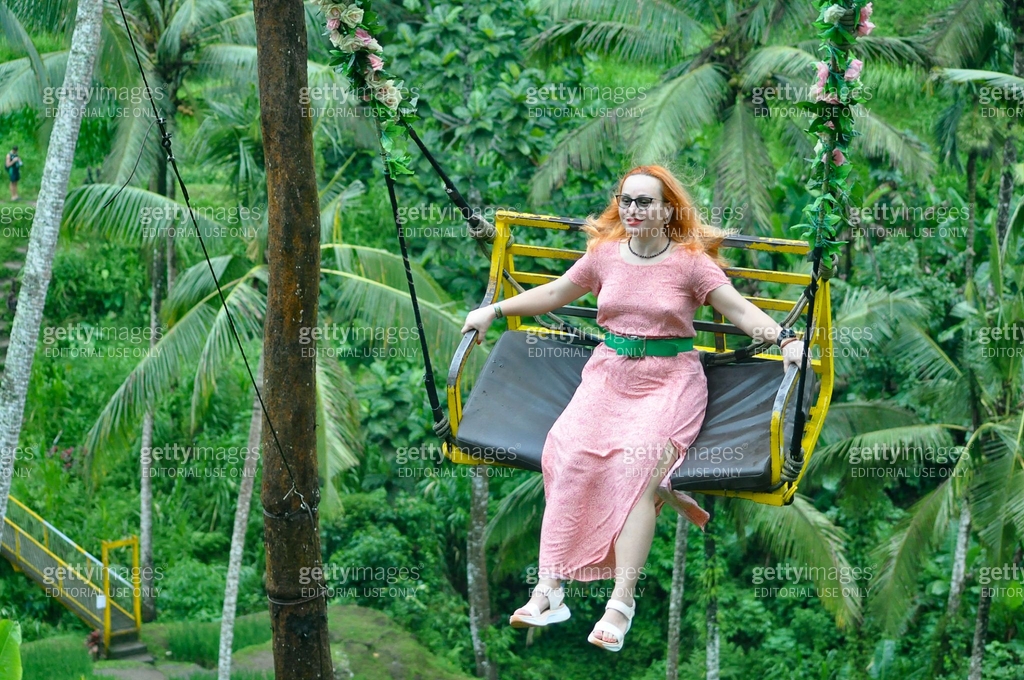 Female rides on a swing at Ceking Rice Terrace or Tegalalang Rice ...