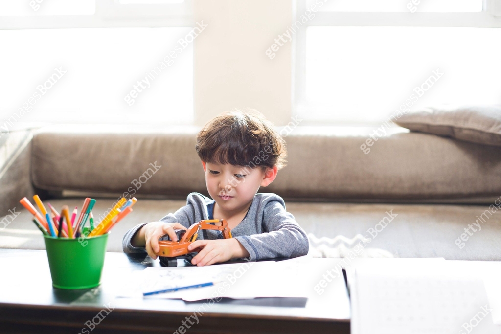 Toy Homework Little boy playing with a toy when doing homework 이미지 (a10743277) - 게티이미지뱅크