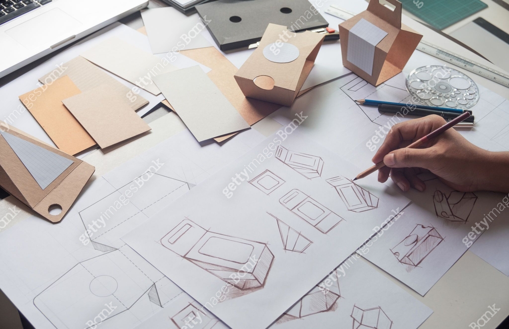 Designer sketching drawing design Brown craft cardboard paper product ...