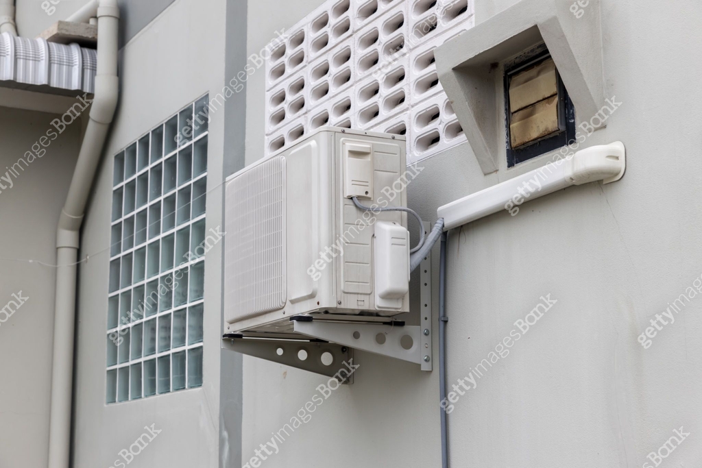 Air conditioner compressor installed in old building. Outdoor split ...