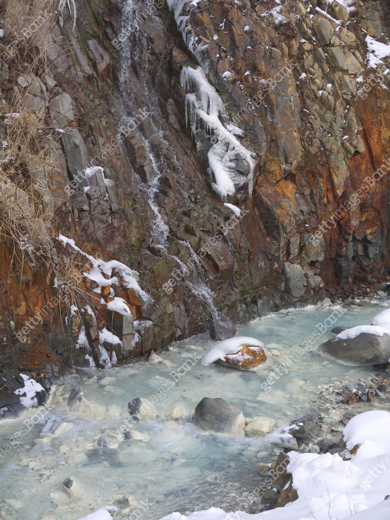 Thermal Sulphur mountain river, steam rising from hot volcanic water ...