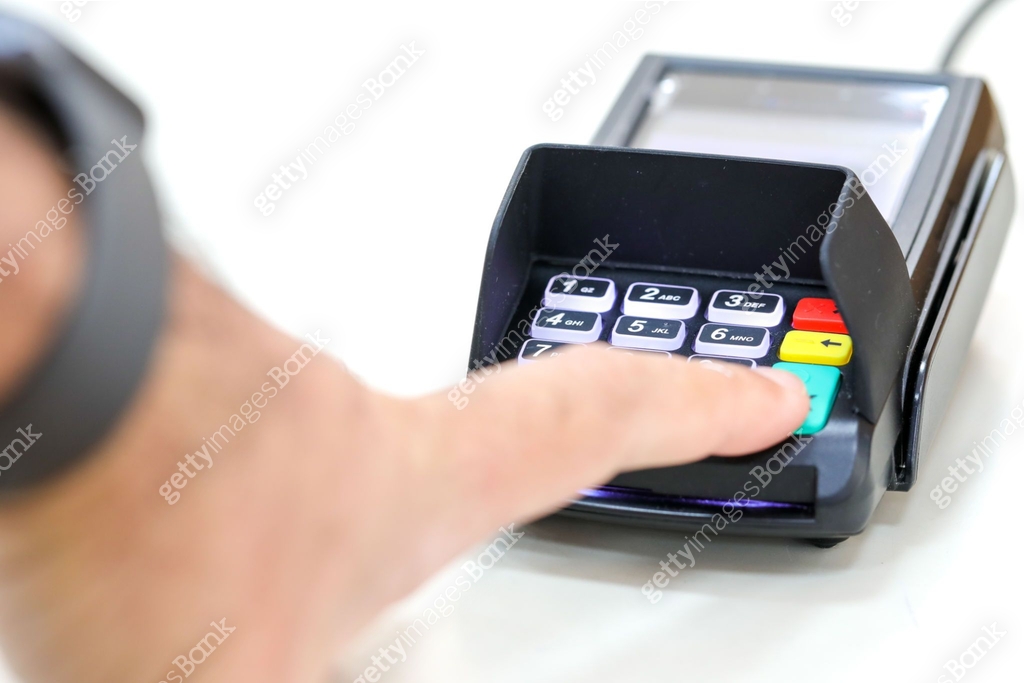 Finger clicks on a transaction confirmation at a credit card payment ...