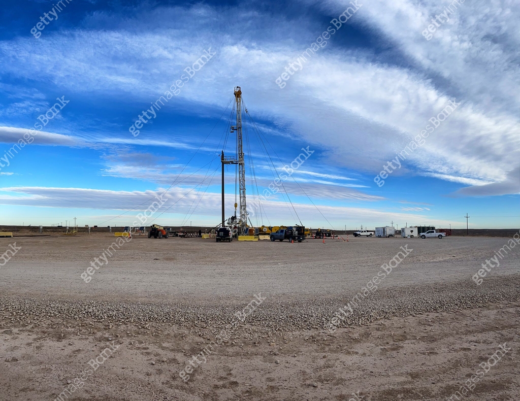 Oil Or Gas Drill Fracking Rig Pad As The Sun Sets In The Background ...