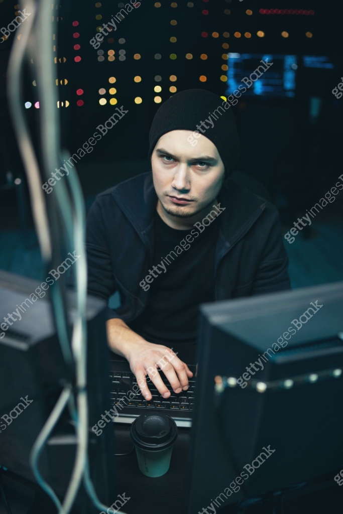 A nervous hacker with dark circles under his eyes hits the table with ...