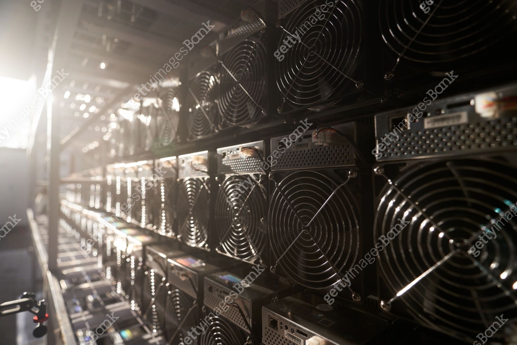 Bitcoin ASIC miners in warehouse. ASIC mining equipment on stand racks ...