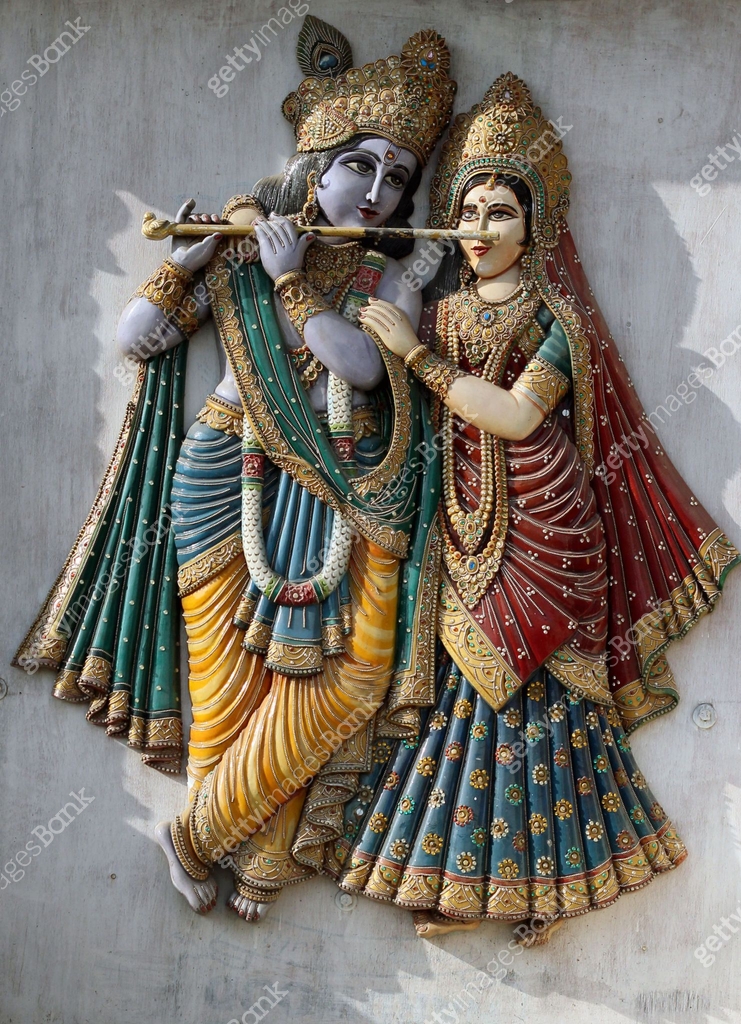 View Of Wooden Carved Indian Hindu God Krishna And Goddess Radha In A view-of-wooden-carved-indian-hindu-god-krishna-and-goddess-radha-in-a
