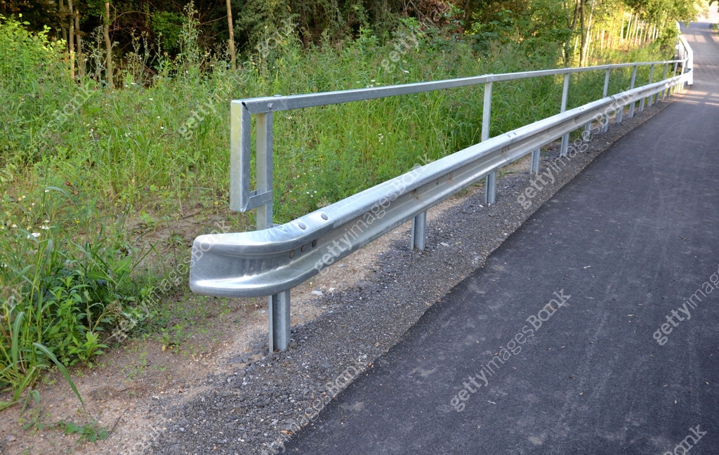 path for cyclists with an asphalt surface. galvanized iron railing over ...