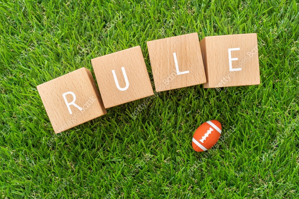 Rugby rule; Wooden blocks with "RULE" text of concept and a rugby ball ...