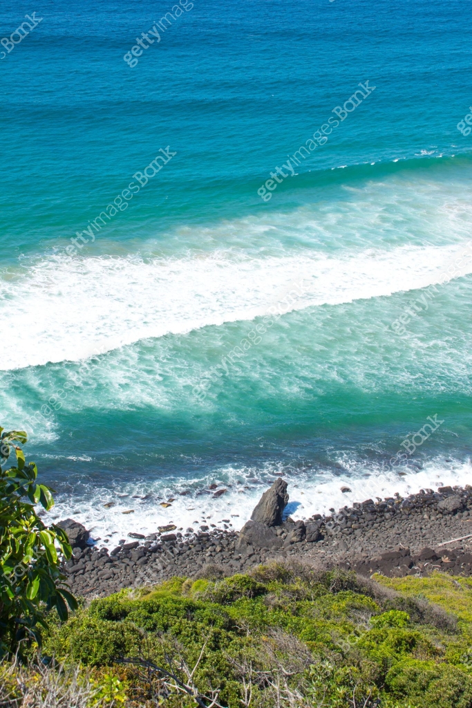 Looking out from Burleigh Headland down the hill to rocks and the ...