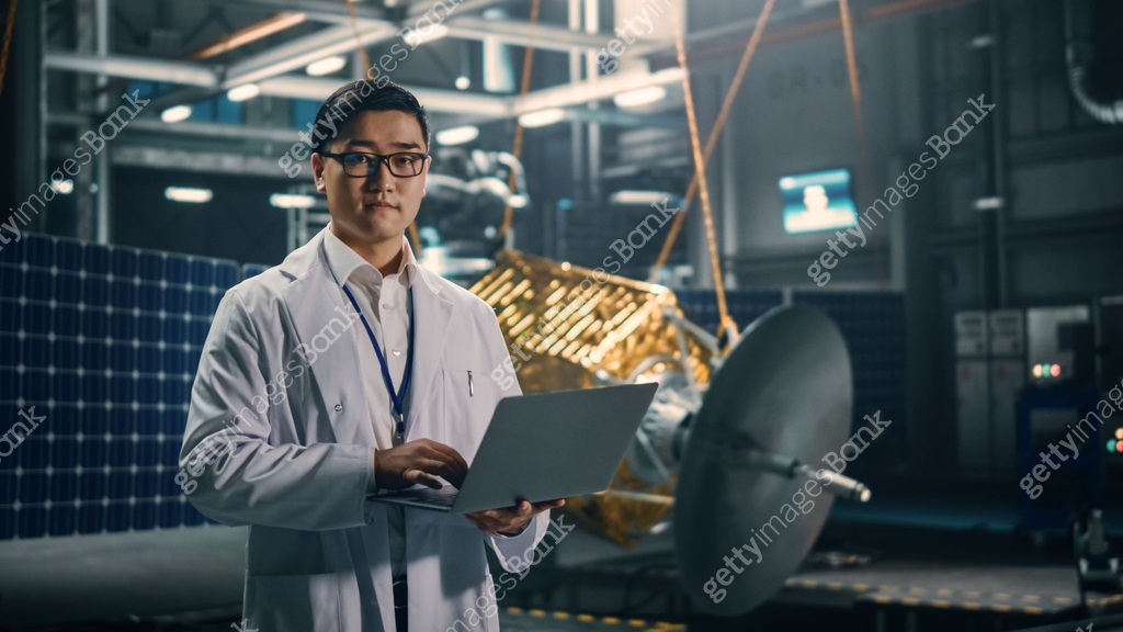 Portrait of Serious Asian Engineer Working on Artificial Satellite ...