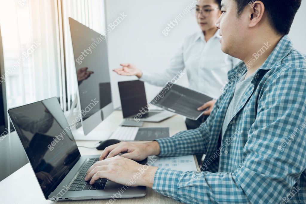 Two software developers are analyzing together about the code written ...