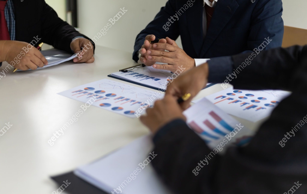 Discuss Work Meeting to discuss strategy analysis and business planning. People in ...