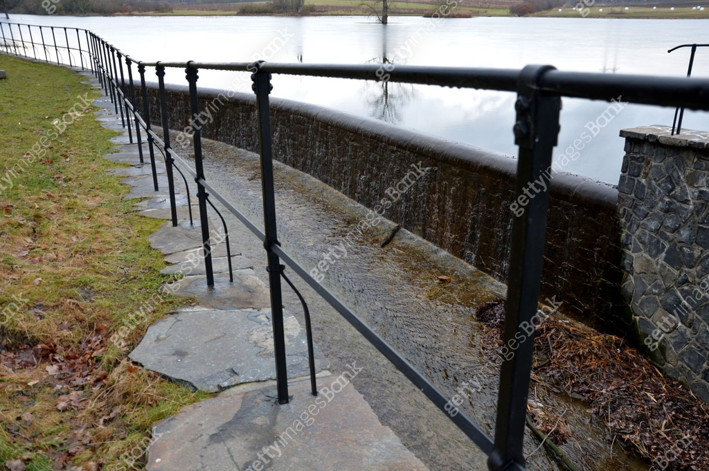 bridge over safety spillway of the dam. stone bridge with natural ...