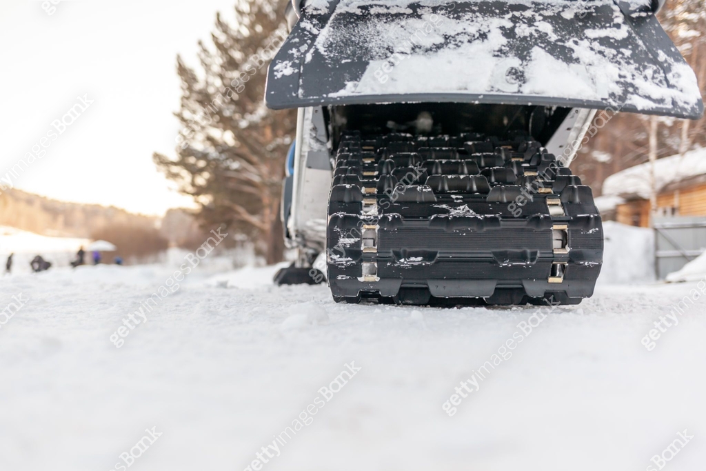 Snowmobile Rear View Snowmobile in winter conditions. Snowmobiling in winter in the north ...