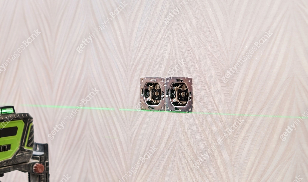 Checking the installed outlets on the wall of the apartment with a ...