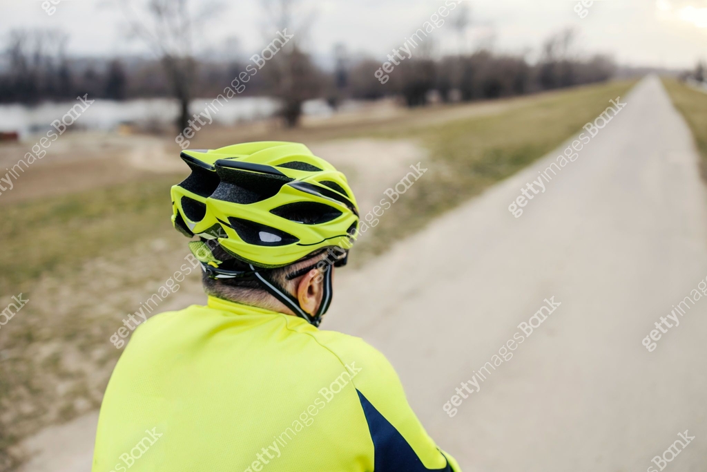 Bicycle Rider Rear View Rear view of a senior bicycle rider riding a bike in nature. 이미지 ...