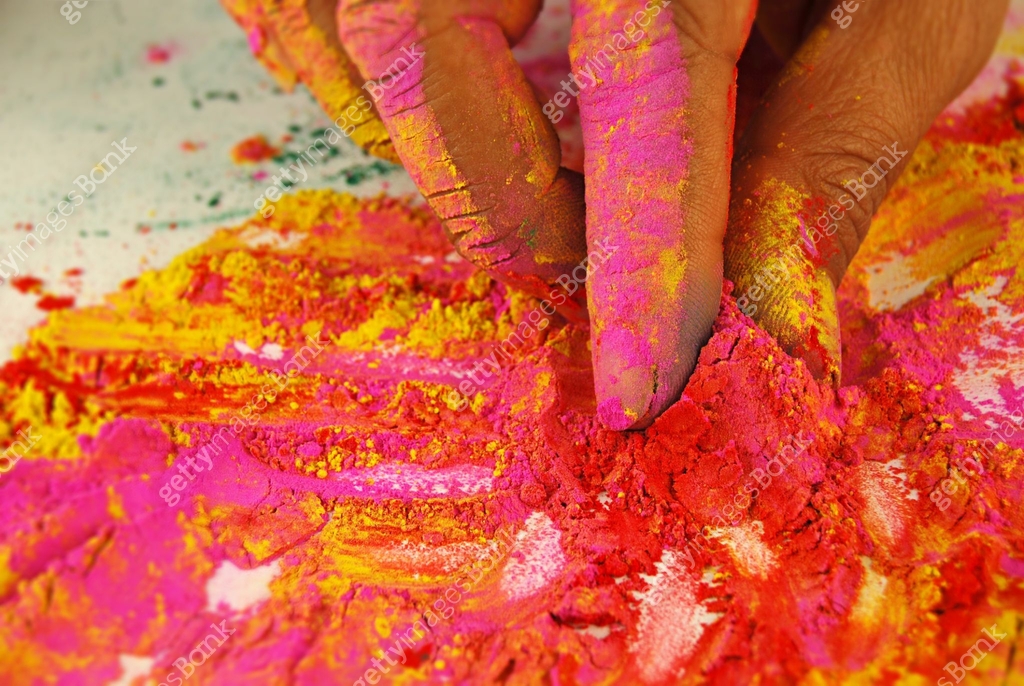 One human hand holding and picking powder colour mix mixture of holi ...