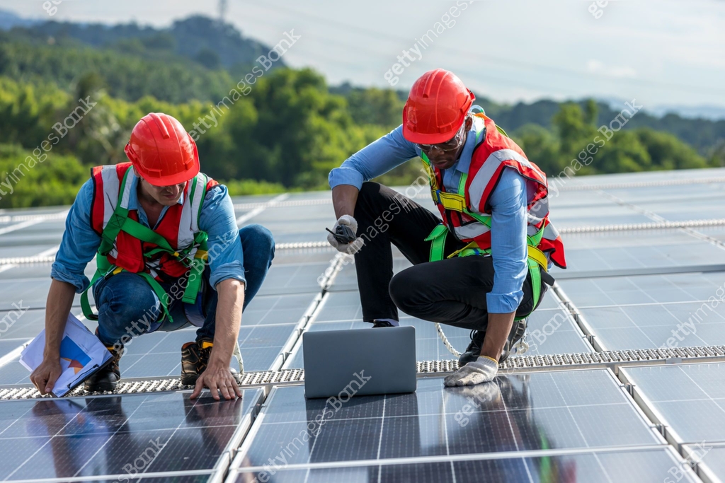 Team Engineer working setup Solar panel at the roof top. Team Engineer ...
