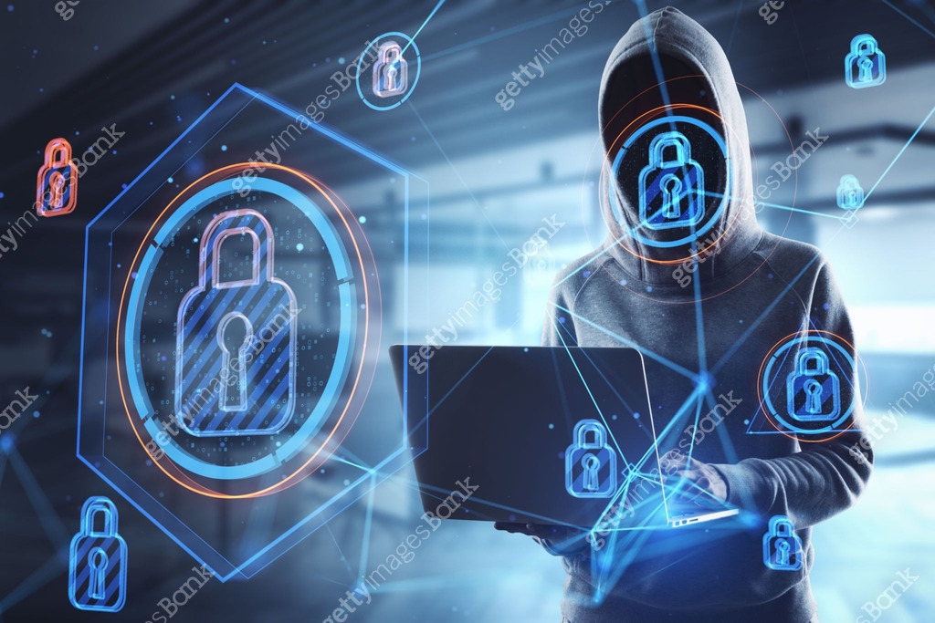 Hacker in blurry office interior using laptop with abstract glowing ...