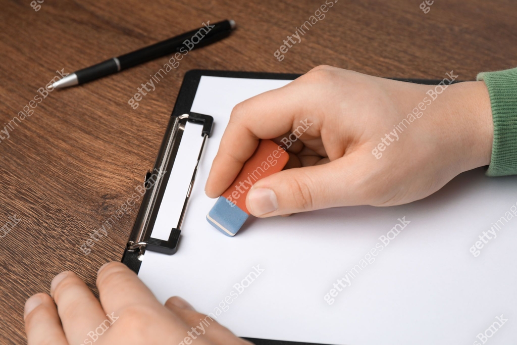 Man Erasing Notes Man erasing something on paper at wooden table, closeup 이미지 (1453972140 ...