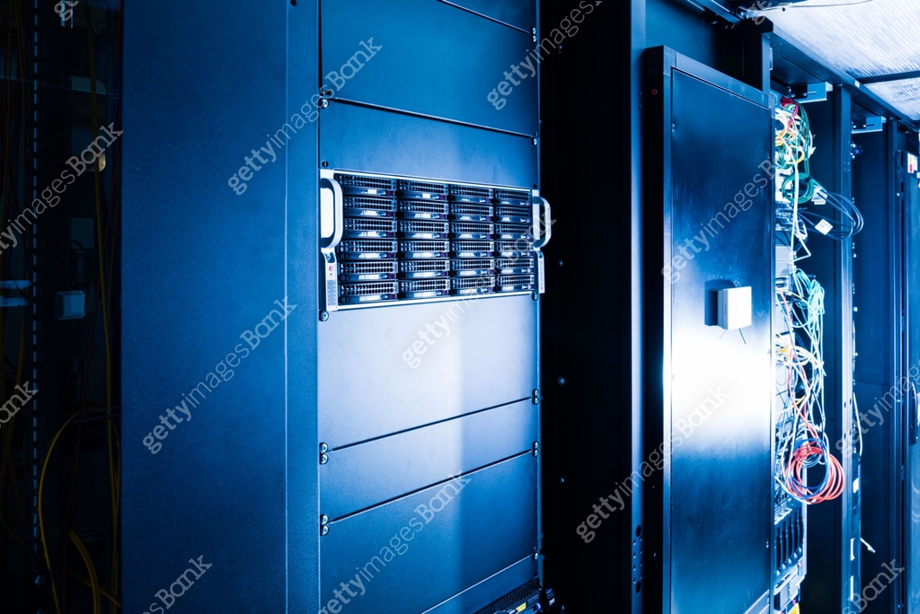 Server racks filled with computer hardware inside internet datacenter ...