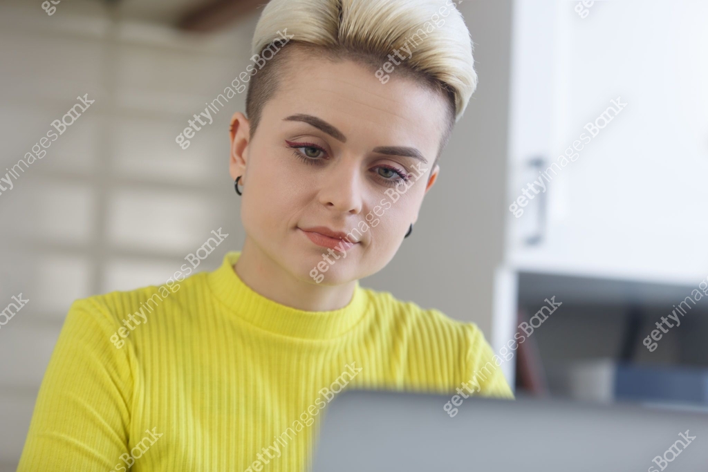 Portrait of female programmer coding on computer at home. Young woman ...
